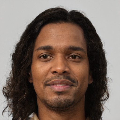 Neutral black young-adult male with long  brown hair and brown eyes