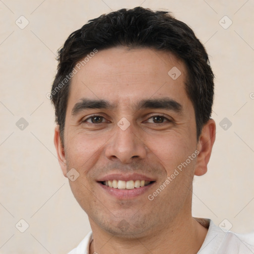 Joyful white young-adult male with short  black hair and brown eyes