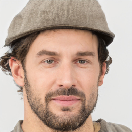 Joyful white adult male with short  brown hair and grey eyes