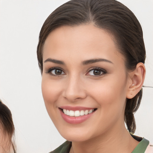 Joyful white young-adult female with medium  brown hair and brown eyes