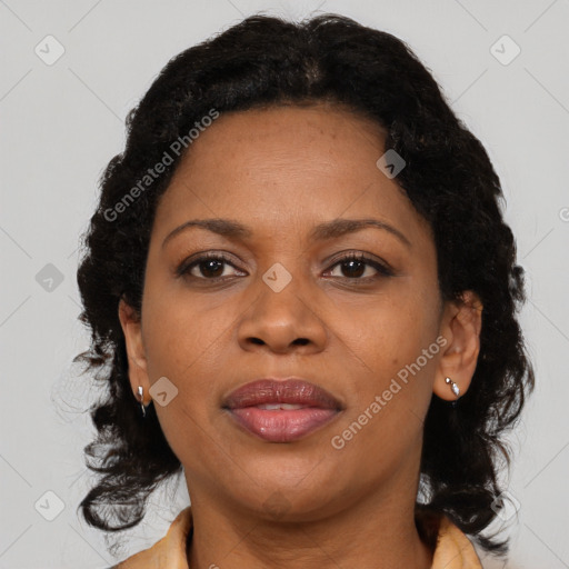 Joyful black adult female with medium  brown hair and brown eyes