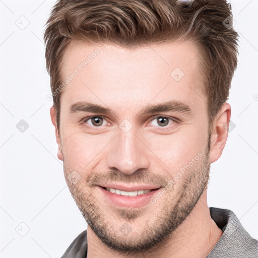 Joyful white young-adult male with short  brown hair and grey eyes