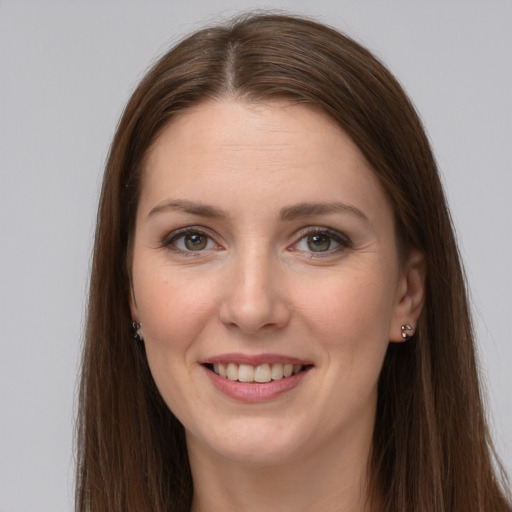 Joyful white young-adult female with long  brown hair and grey eyes