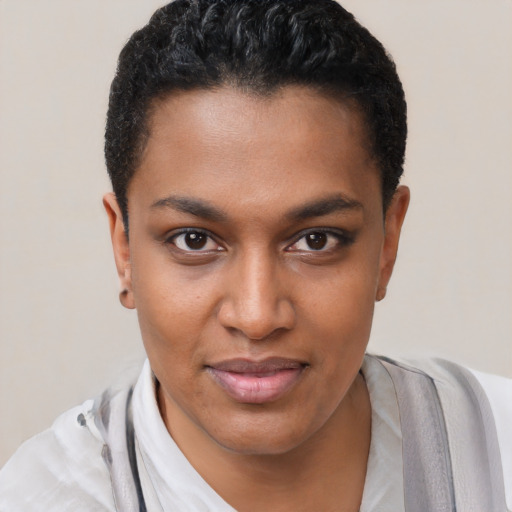 Joyful black young-adult female with short  black hair and brown eyes