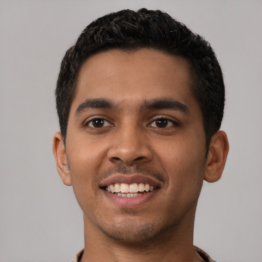Joyful latino young-adult male with short  black hair and brown eyes