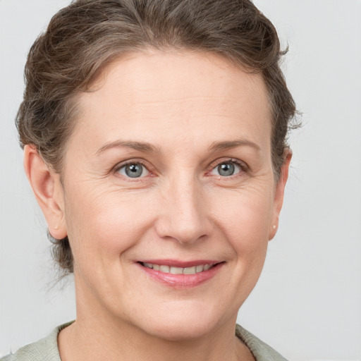 Joyful white adult female with short  brown hair and grey eyes