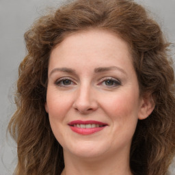 Joyful white young-adult female with long  brown hair and green eyes