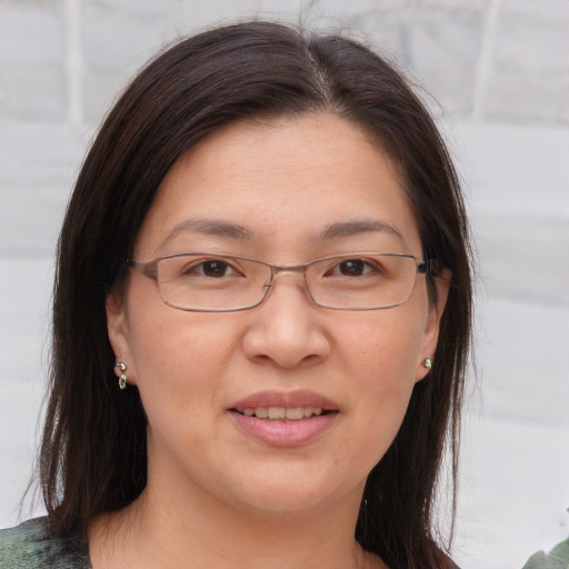 Joyful white adult female with medium  brown hair and brown eyes