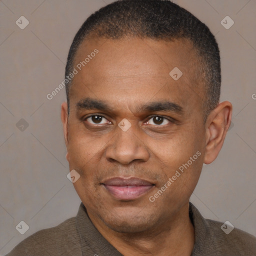 Joyful black adult male with short  brown hair and brown eyes