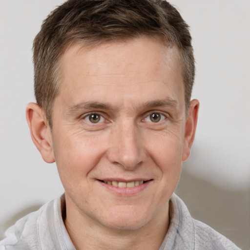 Joyful white adult male with short  brown hair and grey eyes