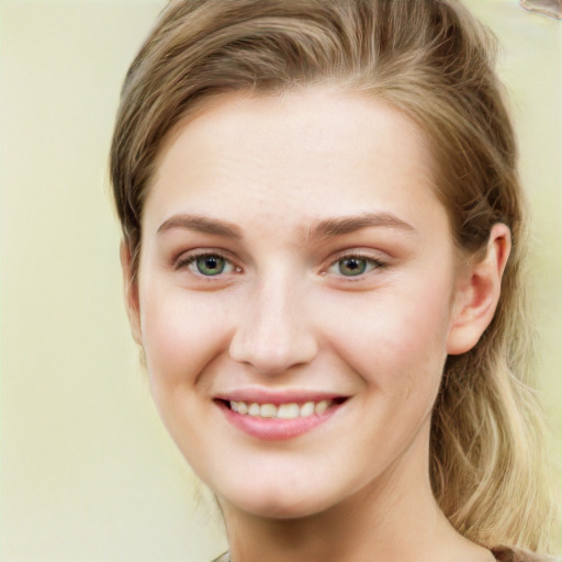 Joyful white young-adult female with long  brown hair and green eyes