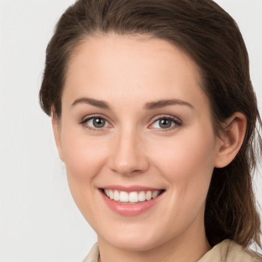 Joyful white young-adult female with medium  brown hair and grey eyes