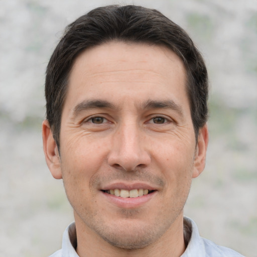 Joyful white adult male with short  brown hair and brown eyes