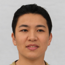 Joyful asian young-adult male with short  brown hair and brown eyes