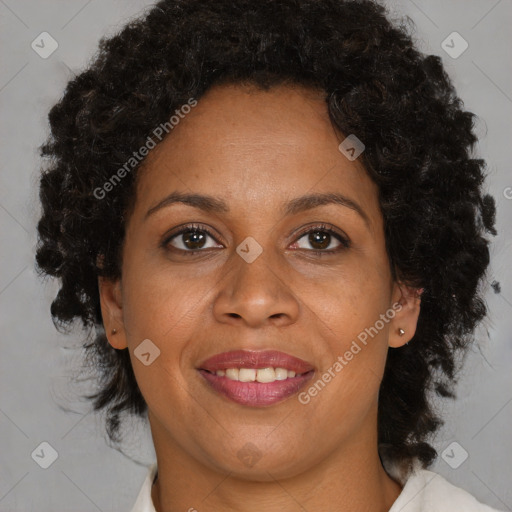 Joyful black adult female with medium  brown hair and brown eyes