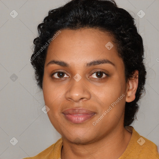 Joyful black young-adult female with long  black hair and brown eyes