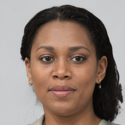 Joyful black adult female with medium  black hair and brown eyes