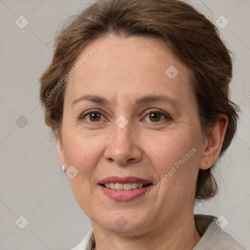 Joyful white adult female with medium  brown hair and grey eyes