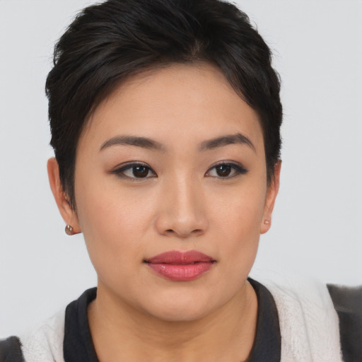 Joyful asian young-adult female with short  brown hair and brown eyes