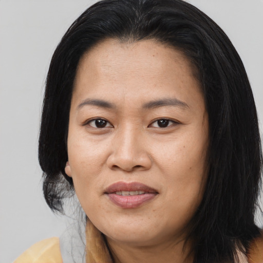 Joyful asian adult female with long  brown hair and brown eyes