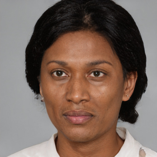 Joyful black adult female with medium  black hair and brown eyes