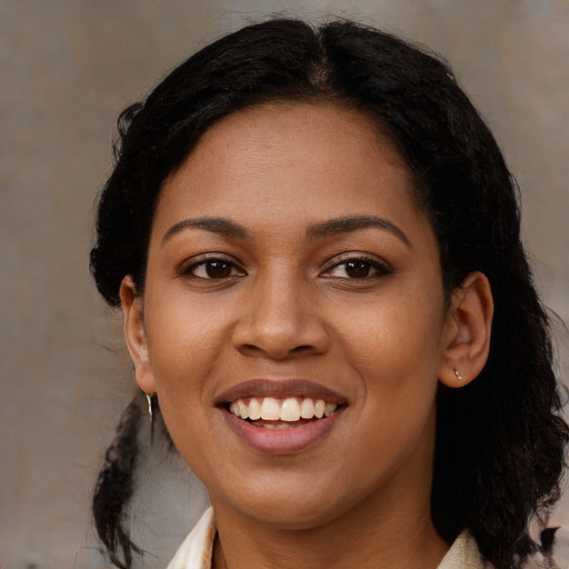 Joyful black young-adult female with medium  black hair and brown eyes