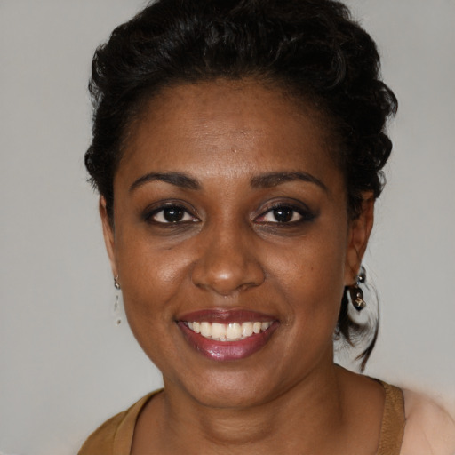 Joyful black young-adult female with short  brown hair and brown eyes