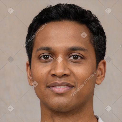 Joyful black young-adult male with short  black hair and brown eyes