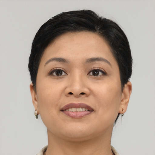 Joyful asian young-adult female with short  brown hair and brown eyes
