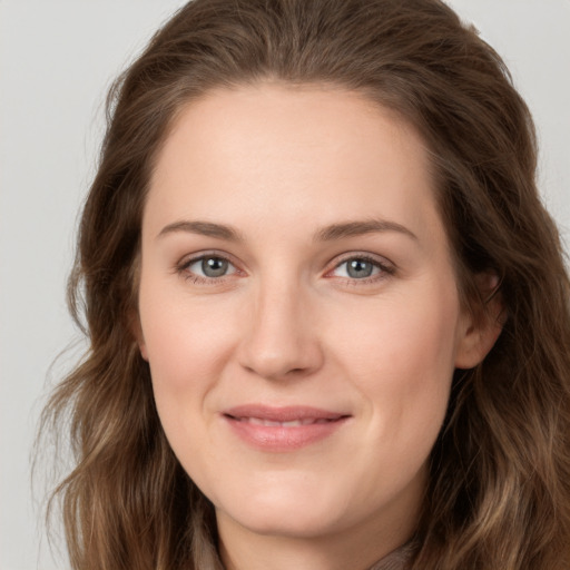 Joyful white young-adult female with long  brown hair and grey eyes