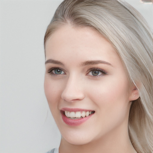 Joyful white young-adult female with long  brown hair and blue eyes