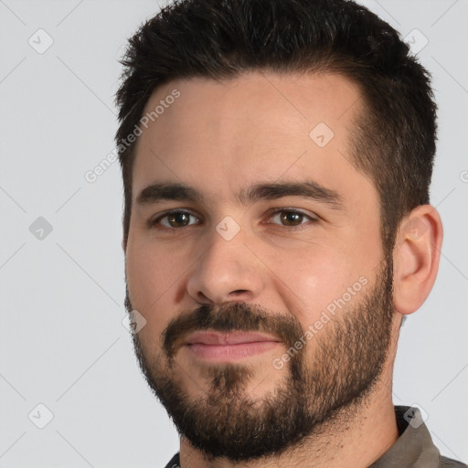 Joyful white young-adult male with short  black hair and brown eyes