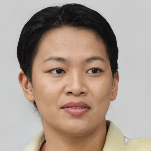 Joyful asian young-adult female with short  brown hair and brown eyes