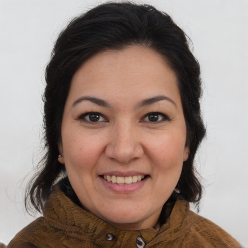 Joyful white adult female with long  brown hair and brown eyes