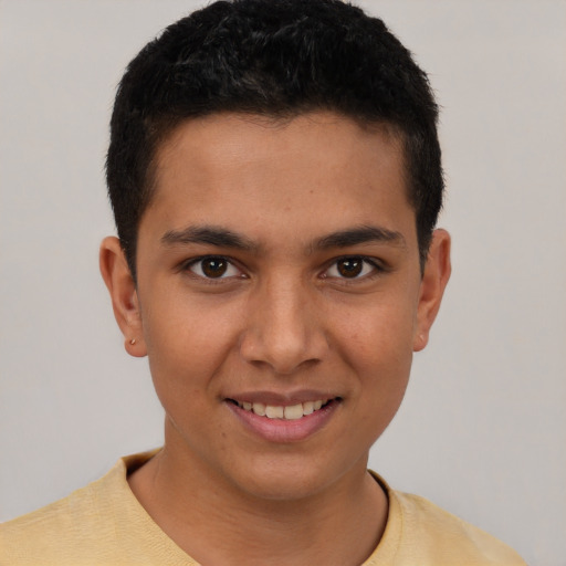 Joyful latino young-adult male with short  brown hair and brown eyes