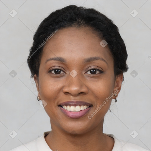 Joyful black young-adult female with short  black hair and brown eyes