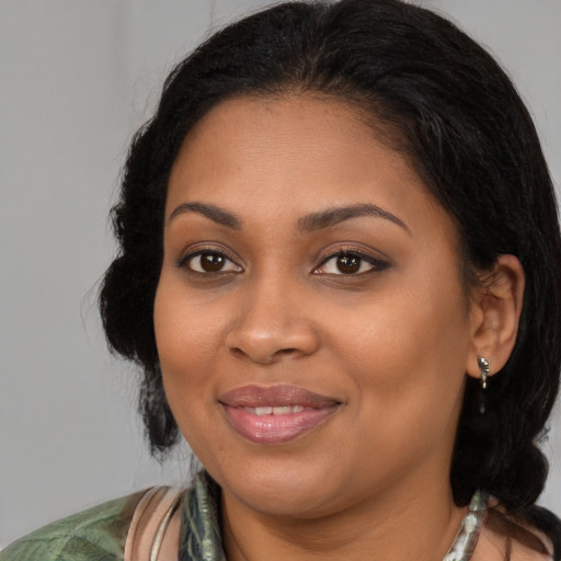 Joyful black young-adult female with medium  brown hair and brown eyes