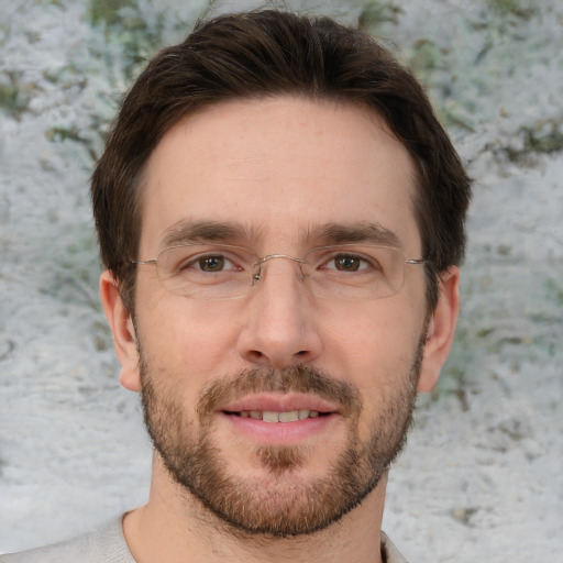 Joyful white adult male with short  brown hair and brown eyes