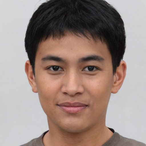 Joyful asian young-adult male with short  black hair and brown eyes