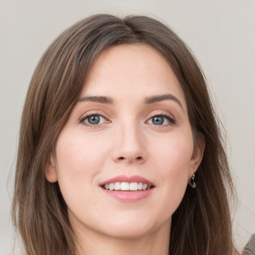 Joyful white young-adult female with long  brown hair and grey eyes