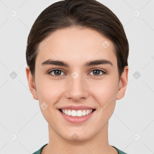 Joyful white young-adult female with short  brown hair and brown eyes