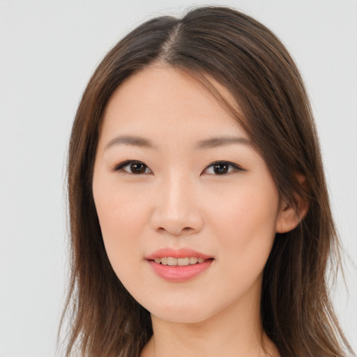 Joyful asian young-adult female with long  brown hair and brown eyes