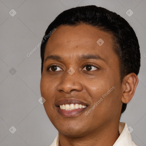 Joyful black young-adult female with short  black hair and brown eyes