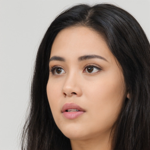 Neutral latino young-adult female with long  black hair and brown eyes