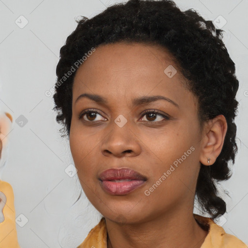 Joyful black young-adult female with long  black hair and brown eyes