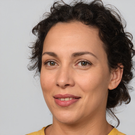 Joyful white adult female with medium  brown hair and brown eyes