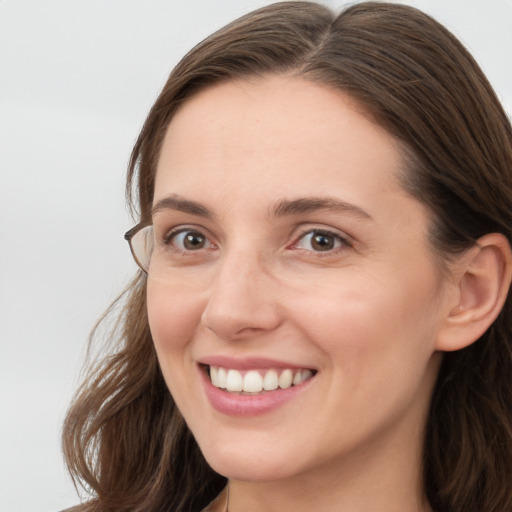 Joyful white young-adult female with long  brown hair and grey eyes