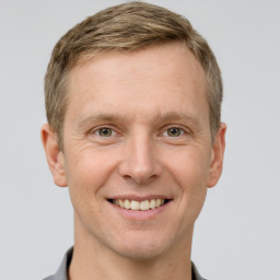 Joyful white adult male with short  brown hair and grey eyes