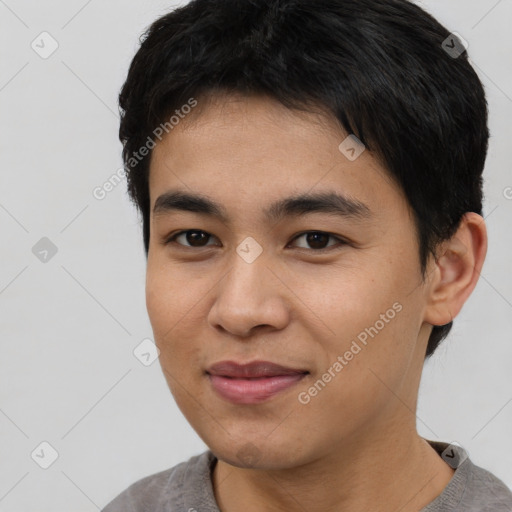 Joyful asian young-adult male with short  black hair and brown eyes