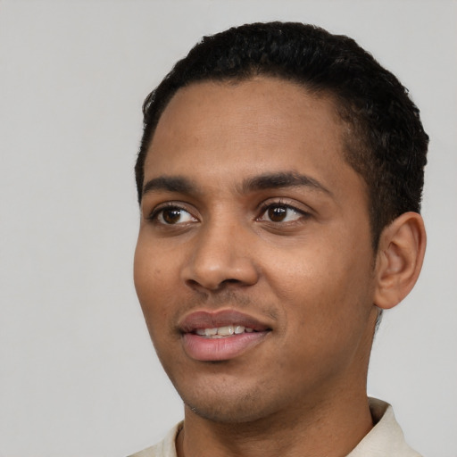 Joyful latino young-adult male with short  black hair and brown eyes